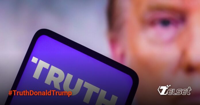 Truth+ Milik Donald Trump: Surganya Teori Konspirasi dan Konten Religi Ekstrem Truth Social logo appears on a smartphone in front of Donald Trump