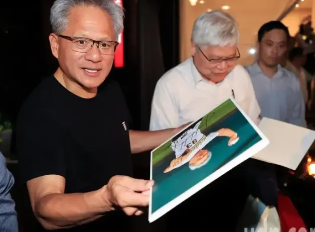 Man holding a signed photo alongside two others in a well-lit room.
