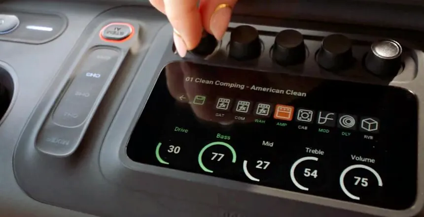 A hand adjusting knobs on the JBL BandBox Trio speaker